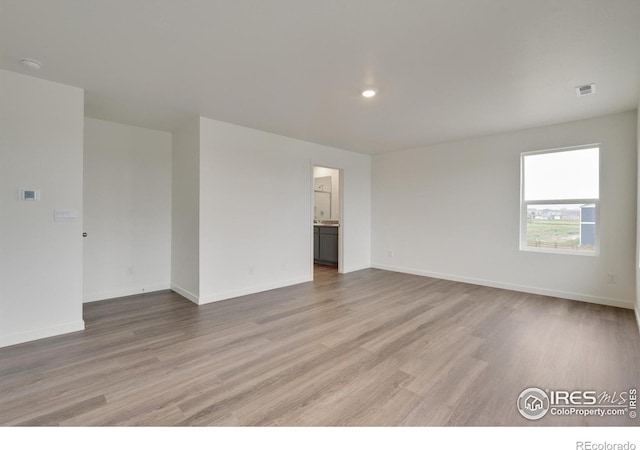1639 Pinnacle Ave, Lochbuie, CO 80603 - spare room featuring light wood finished floors, recessed lighting, and a smoke detector