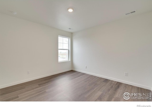1639 Pinnacle Ave, Lochbuie, CO 80603 - spare room with wood finished floors and a smoke detector