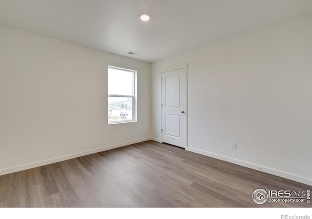 1639 Pinnacle Ave, Lochbuie, CO 80603 - empty room featuring wood finished floors and baseboards