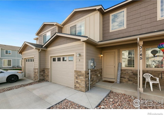 3145 Alybar Dr # 16B, Wellington, CO 80549 - townhome / multi-family property featuring stone siding, driveway, a porch, and board and batten siding