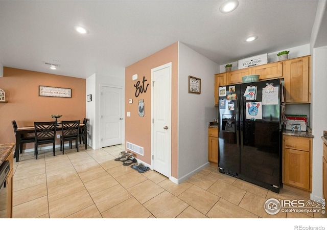 3145 Alybar Dr # 16B, Wellington, CO 80549 - kitchen with black fridge, recessed lighting, light tile patterned floors, and dishwashing machine