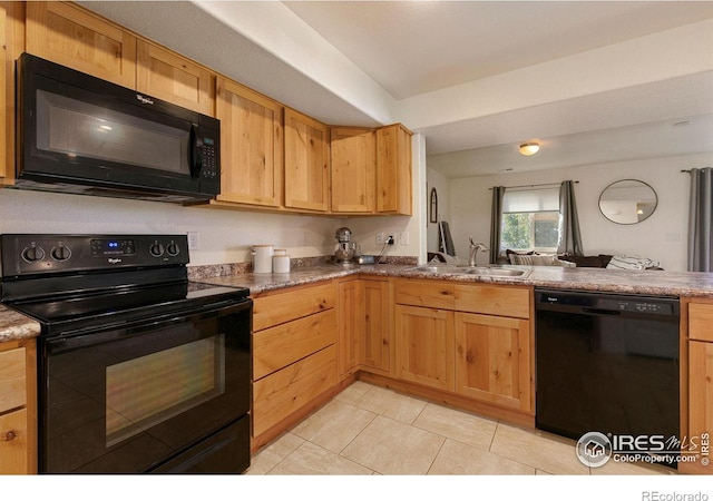 3145 Alybar Dr # 16B, Wellington, CO 80549 - kitchen featuring black appliances, light brown cabinets, light tile patterned flooring, and a peninsula