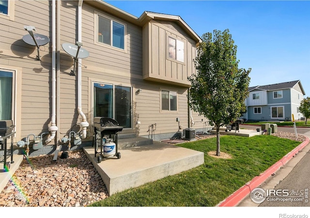 3145 Alybar Dr # 16B, Wellington, CO 80549 - back of house with a patio, a lawn, and board and batten siding