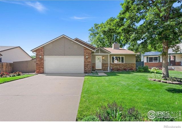4222 W 22nd Street Rd, Greeley, CO 80634 - ranch-style home featuring brick siding, an attached garage, a chimney, and driveway