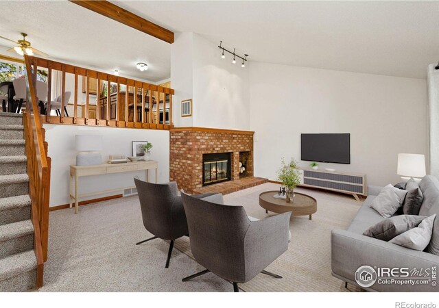 4222 W 22nd Street Rd, Greeley, CO 80634 - living area featuring stairway, carpet floors, a fireplace, rail lighting, and a ceiling fan