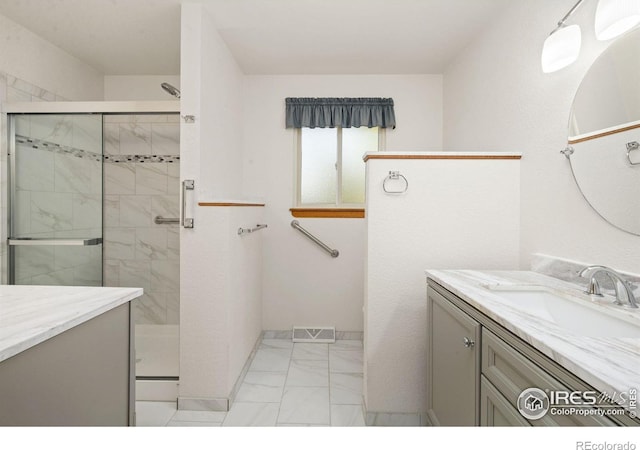 4222 W 22nd Street Rd, Greeley, CO 80634 - bathroom with marble look tile flooring, vanity, and a shower stall