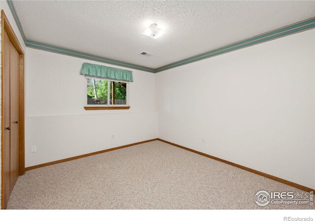 4222 W 22nd Street Rd, Greeley, CO 80634 - carpeted spare room with a textured ceiling and ornamental molding