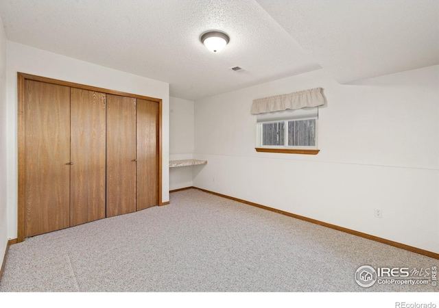 4222 W 22nd Street Rd, Greeley, CO 80634 - unfurnished bedroom featuring carpet floors, a textured ceiling, and a closet