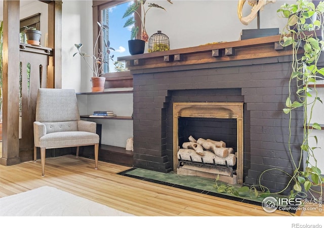 1217 N Downing St Unit 4, Denver, CO 80218 - living area featuring wood finished floors and a brick fireplace