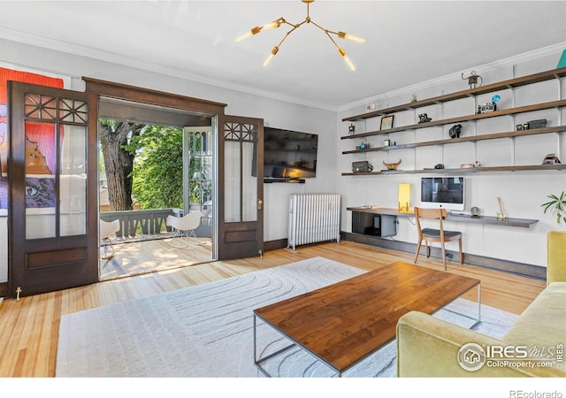 1217 N Downing St Unit 4, Denver, CO 80218 - living area with radiator, crown molding, a chandelier, and wood finished floors