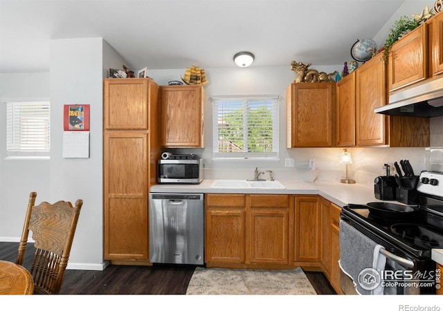 1144-1148 E 5th St, Loveland, CO 80537 - kitchen with stainless steel appliances, under cabinet range hood, dark wood-style flooring, and light countertops