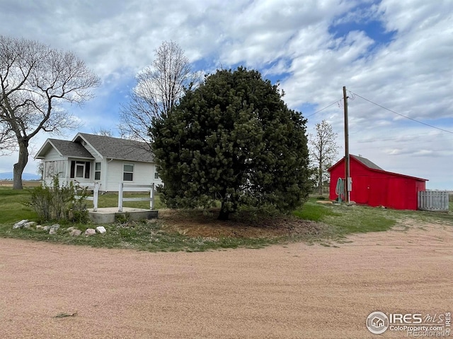 31496 County Road 29, Greeley, CO 80631 - view of side of home with an outbuilding and roof with shingles