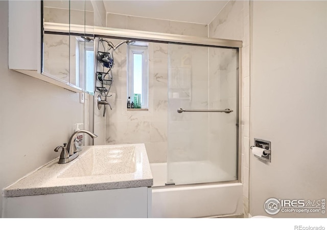 4009 W 52nd Ave, Denver, CO 80212 - bathroom featuring vanity and bath / shower combo with glass door
