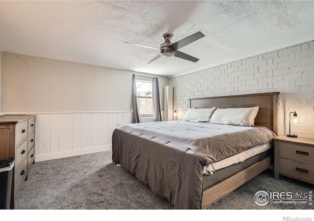 4009 W 52nd Ave, Denver, CO 80212 - carpeted bedroom featuring a textured ceiling, wainscoting, and ceiling fan