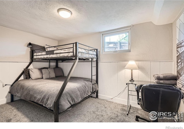 4009 W 52nd Ave, Denver, CO 80212 - bedroom with a textured ceiling, carpet floors, and wainscoting