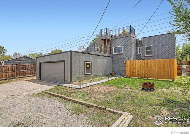 4009 W 52nd Ave, Denver, CO 80212 - back of property featuring a fire pit, driveway, and an outdoor structure