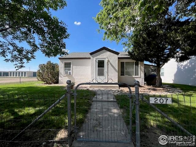 205-207 W 3rd Ave, Wiggins, CO 80654 - view of front facade featuring stucco siding and a gate