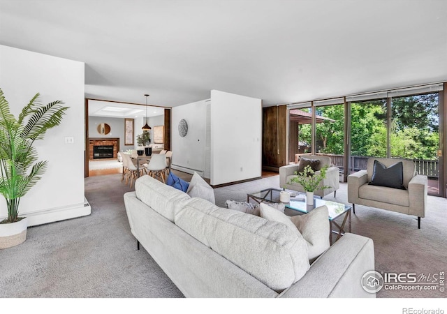 525 13th St, Boulder, CO 80302 - carpeted living room with healthy amount of natural light, a fireplace with raised hearth, and a baseboard heating unit