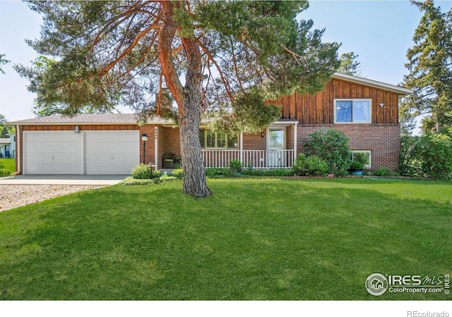 8840 Niwot Rd, Niwot, CO 80503 - view of front facade featuring an attached garage, a front yard, driveway, and brick siding
