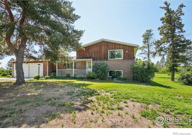 8840 Niwot Rd, Niwot, CO 80503 - view of front facade featuring covered porch, brick siding, an attached garage, and a front yard