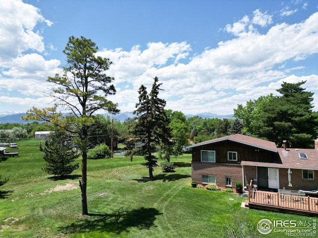 8840 Niwot Rd, Niwot, CO 80503 - view of grassy yard with a deck with mountain view