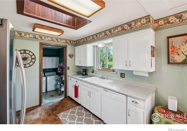 8840 Niwot Rd, Niwot, CO 80503 - kitchen with white dishwasher, light countertops, white cabinetry, separate washer and dryer, and freestanding refrigerator
