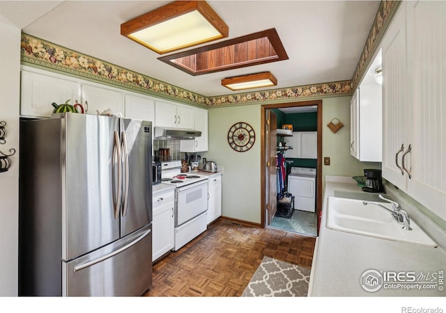 8840 Niwot Rd, Niwot, CO 80503 - kitchen with freestanding refrigerator, white range with electric stovetop, washer / clothes dryer, under cabinet range hood, and white cabinets