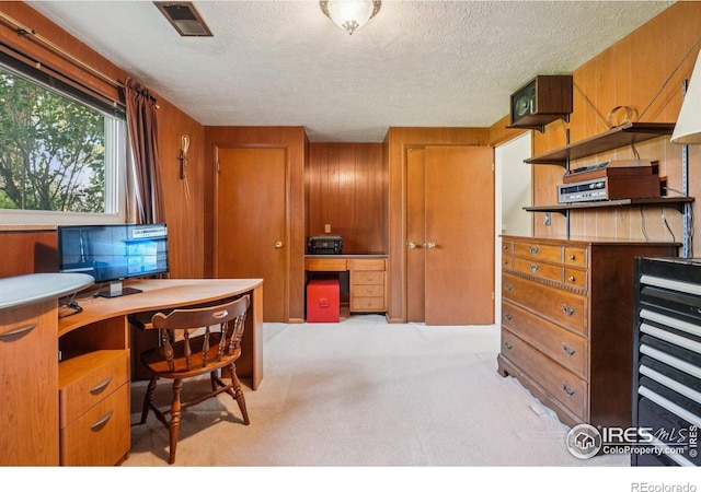 8840 Niwot Rd, Niwot, CO 80503 - office area featuring carpet, wood walls, and a textured ceiling