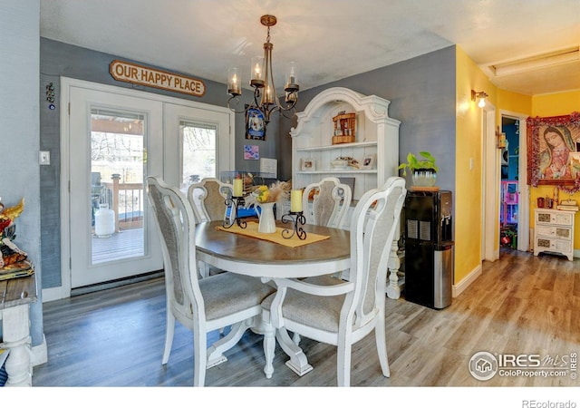 7970 Wolff Ct, Westminster, CO 80030 - dining room featuring light wood-type flooring and a chandelier