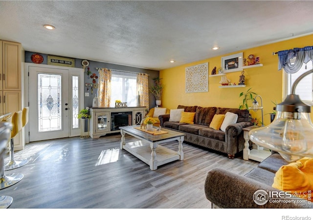 7970 Wolff Ct, Westminster, CO 80030 - living area with light wood finished floors, a textured ceiling, and recessed lighting