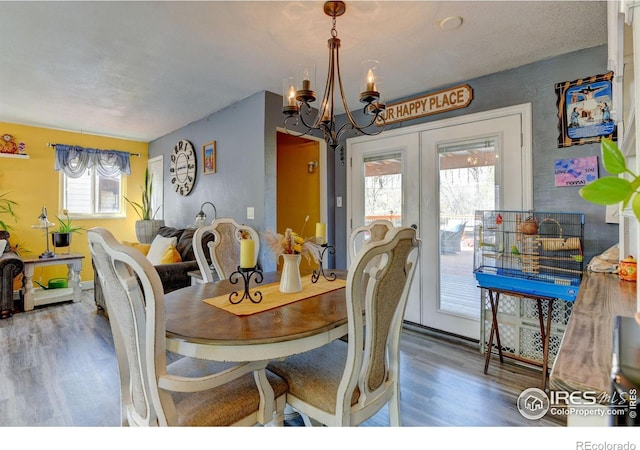 7970 Wolff Ct, Westminster, CO 80030 - dining area with wood finished floors, french doors, and a chandelier