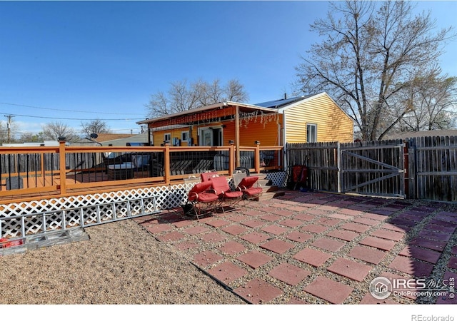 7970 Wolff Ct, Westminster, CO 80030 - rear view of house featuring a gate, a wooden deck, and a patio area
