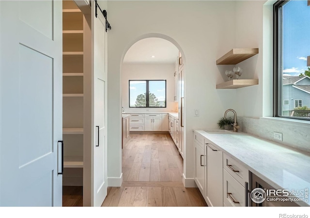 1126 W Enclave Cir, Louisville, CO 80027 - interior space with arched walkways, light wood-type flooring, and backsplash