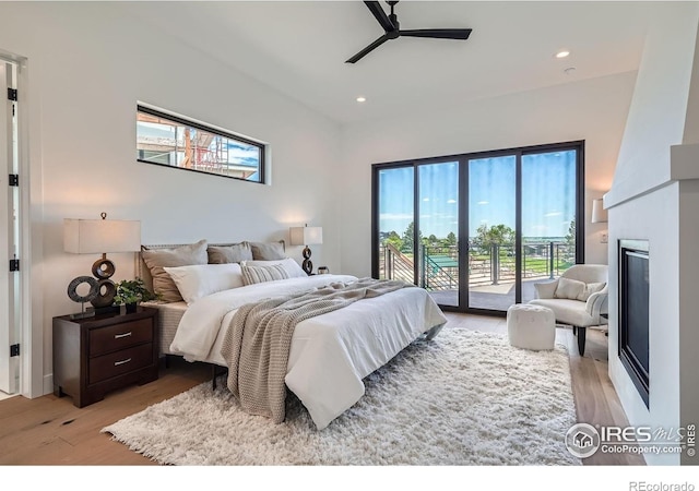 1126 W Enclave Cir, Louisville, CO 80027 - bedroom featuring access to exterior, light wood finished floors, recessed lighting, a large fireplace, and a ceiling fan