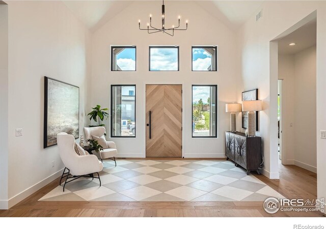 1126 W Enclave Cir, Louisville, CO 80027 - foyer entrance featuring a chandelier and high vaulted ceiling