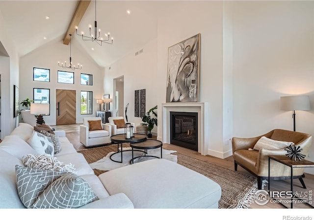 1126 W Enclave Cir, Louisville, CO 80027 - living room with a chandelier, high vaulted ceiling, beamed ceiling, wood finished floors, and a glass covered fireplace