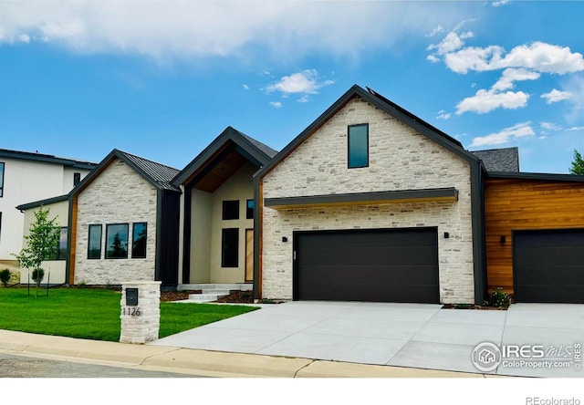 1126 W Enclave Cir, Louisville, CO 80027 - contemporary home with stone siding, a front lawn, concrete driveway, and a garage