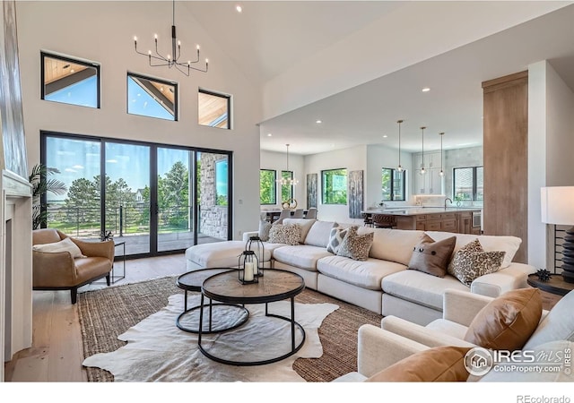 1126 W Enclave Cir, Louisville, CO 80027 - living area featuring a chandelier, light wood-style floors, healthy amount of natural light, recessed lighting, and high vaulted ceiling