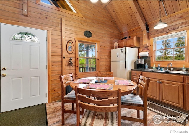 90 Woccon Ct, Red Feather Lakes, CO 80545 - dining space featuring vaulted ceiling, wooden walls, light wood-style floors, and wooden ceiling