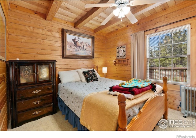 90 Woccon Ct, Red Feather Lakes, CO 80545 - bedroom featuring a wooden ceiling with exposed beams, carpet floors, wood walls, radiator heating unit, and a ceiling fan