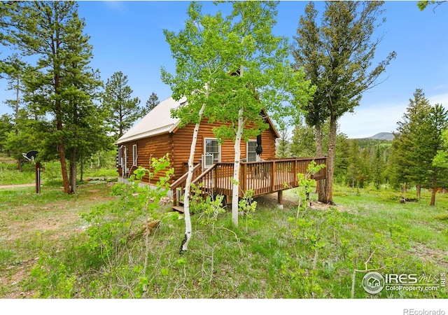 90 Woccon Ct, Red Feather Lakes, CO 80545 - view of home's exterior with a deck with mountain view and log siding