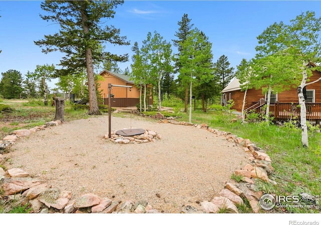90 Woccon Ct, Red Feather Lakes, CO 80545 - view of yard with a wooden deck and an outdoor structure