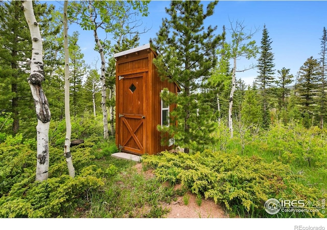 90 Woccon Ct, Red Feather Lakes, CO 80545 - view of shed featuring a view of trees