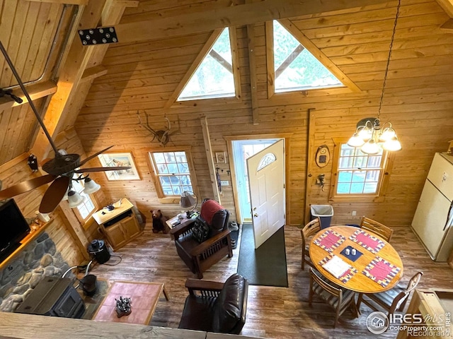 90 Woccon Ct, Red Feather Lakes, CO 80545 - living room with wooden walls, plenty of natural light, a chandelier, wood finished floors, and beamed ceiling