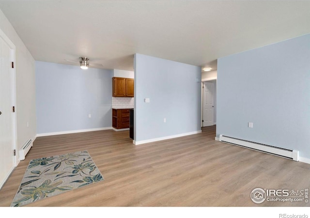 512 E Monroe Dr Unit 329, Fort Collins, CO 80525 - unfurnished living room featuring a baseboard radiator, light wood-style floors, and ceiling fan