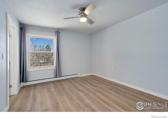 512 E Monroe Dr Unit 329, Fort Collins, CO 80525 - unfurnished room featuring a baseboard radiator, light wood-type flooring, and a ceiling fan