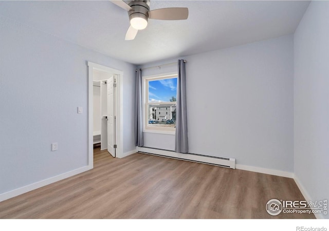 512 E Monroe Dr Unit 329, Fort Collins, CO 80525 - spare room with a baseboard radiator, light wood-style flooring, and a ceiling fan