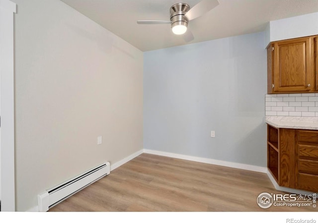 512 E Monroe Dr Unit 329, Fort Collins, CO 80525 - unfurnished dining area featuring baseboard heating, ceiling fan, and light wood-style floors