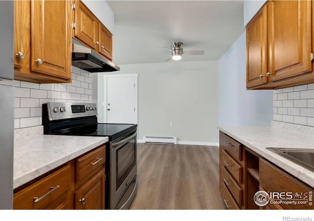 512 E Monroe Dr Unit 329, Fort Collins, CO 80525 - kitchen featuring stainless steel electric stove, ventilation hood, a baseboard radiator, and brown cabinets