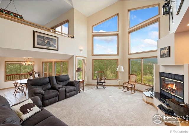 366 N Rim Rd, Livermore, CO 80536 - living area with a high ceiling, a chandelier, plenty of natural light, a glass covered fireplace, and carpet